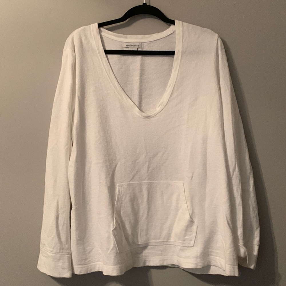 White cotton knit v neck shirt with front pocket.